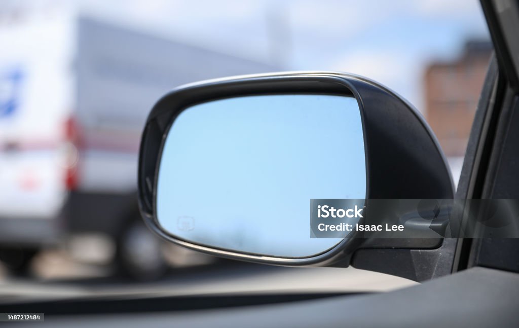 Reflecting on life's journey with the car mirror. A powerful symbol of self-reflection, awareness, and the ability to look back and move forward Analyzing Stock Photo