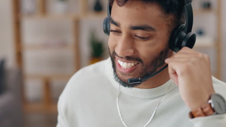 Work from home call center man, agent or consultant talk and laugh in tech support, advice or ecommerce services. Friendly indian person speaking on headset for virtual communication or telemarketing