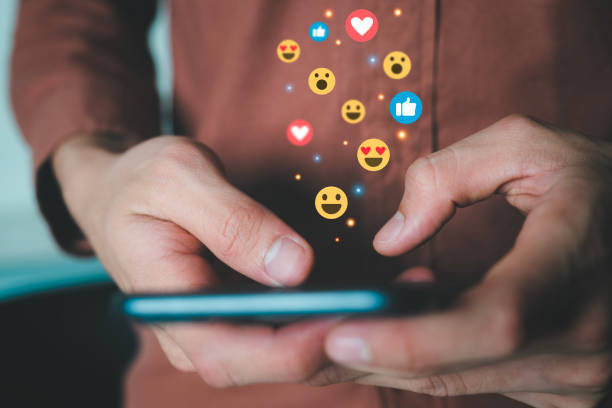 istock Man holding phone connecting with people using social media. 1487213560