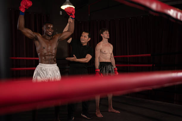 istock Victorious boxer the referee will raise their hands on stage, Muay Thai, Thai martial arts. 1487213650