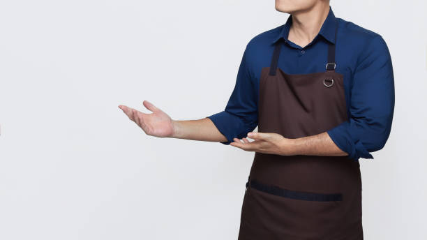 istock Asian Man wearing Apron with both hands showing something 1487215086