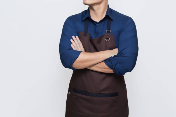 istock Asian Man wearing Apron with folded hands, confident and calm gesture 1487215089