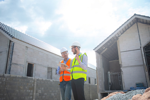 Engineer working with architect in house under construction