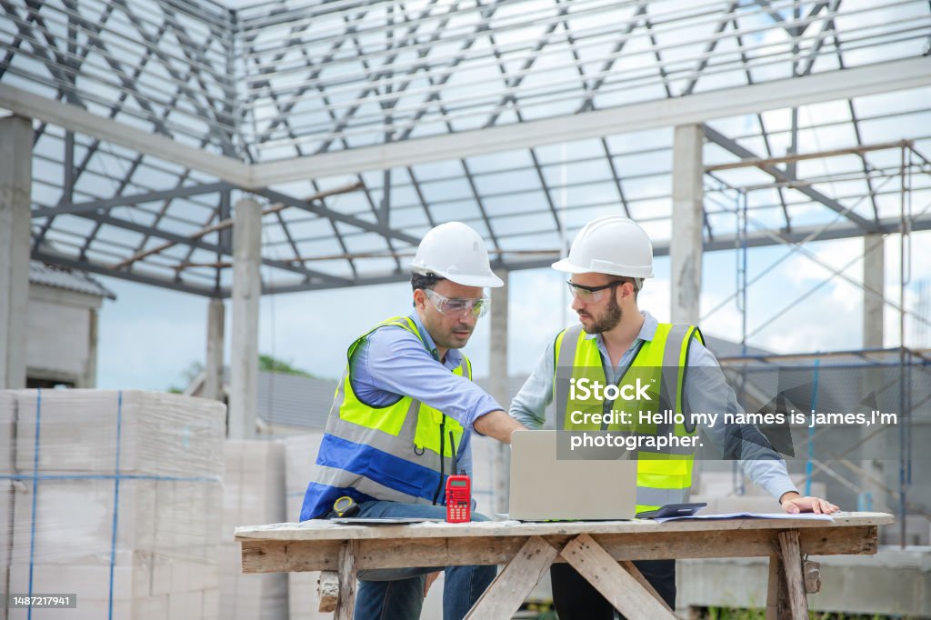 Structural Engineer At Work Structural Engineer And Workers Are Working On Large Construction Site ...