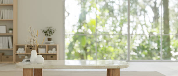 Mockup space on minimal white marble coffee tabletop in minimal bright living room