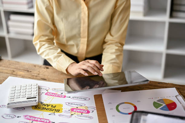 istock A professional businesswoman using her digital tablet at her desk. 1487222344
