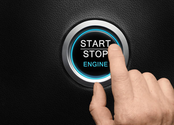 istock Finger about to press Engine start button with blue glowing ring in a modern car 1487226527