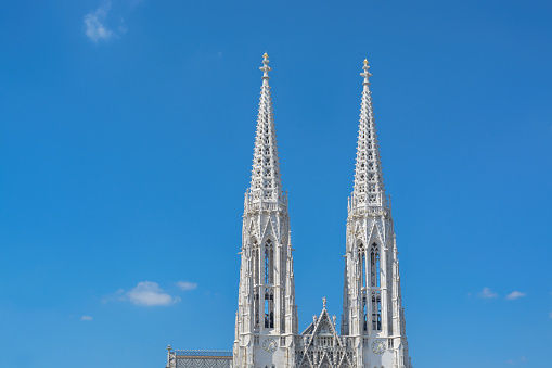 Towers of the Votivkirche in Vienna against the blue sky in horizontal format