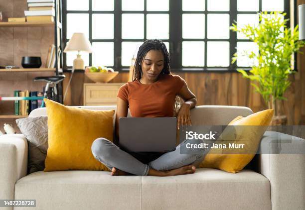 A Latin Girl Is Writing While Studying At Home Stock Photo - Download Image Now - 20-24 Years, Adolescence, Adult