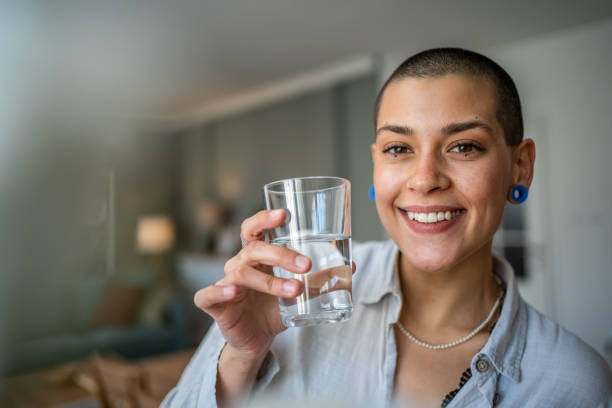 istock Young beautiful woman drinks water during class, dehydration 1487228836
