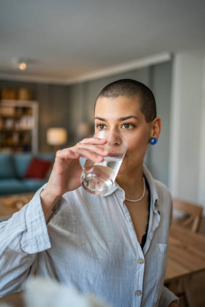 istock Young beautiful woman drinks water during class, dehydration 1487228839