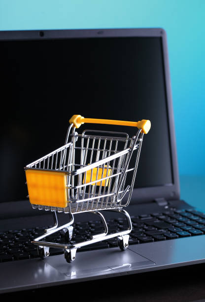 istock Online shopping e-commerce shopping cart with notebook 1487228926