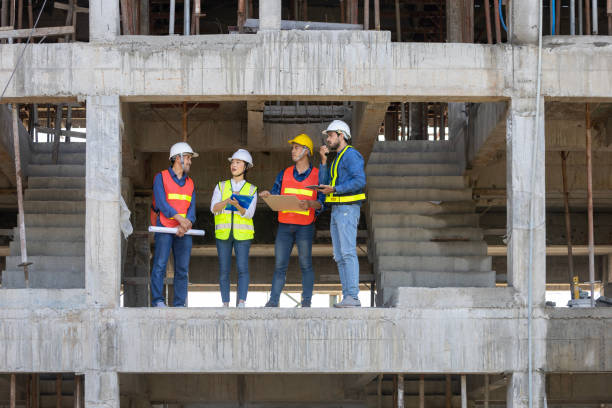 istock Team of engineer, architect, contractor and foreman meeting and consulting in construction building site for inspection in real estate development project industry and specification quality control 1487230030