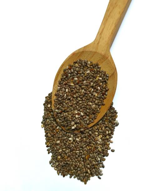 白い背景にスプーンにチアシードの山 - tablespoon chia healthy eating seed ストックフォトと画像