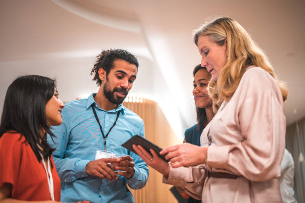 istock Multicultural Group of Colleagues Engaged in Collaboration with Wireless Technology 1487231787