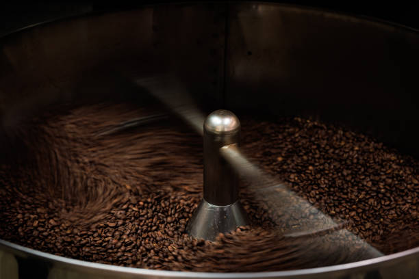 istock Coffee roaster machine at coffee roasting mixing process. Roasted spinning cooler professional machines and fresh brown coffee beans, low speed shutter movement and motion blur coffee grain, 1487233420