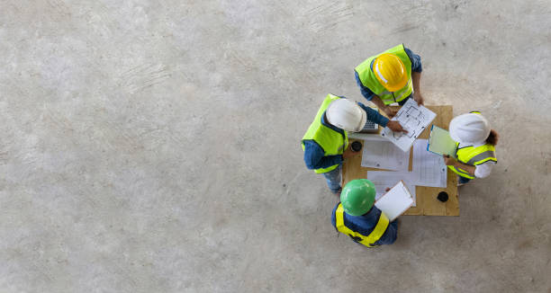 top view of engineer, architect, contractor and foreman meeting at the construction building site with floor plan for real estate development project industry and housing timeline usage - subcontractor imagens e fotografias de stock