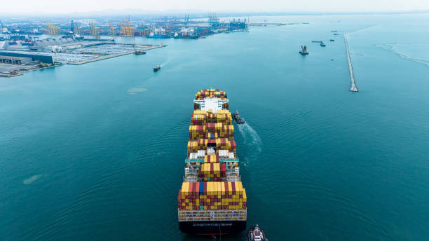 istock cargo container ship carrying in sea to import export goods and distributing products to dealer and consumers across asia pacific worldwide, global business and industry delivery service  by container ship Transport. 1487235379