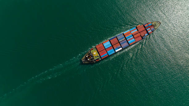 istock cargo container ship sailing in sea to import export goods and distributing products to dealer and consumers across worldwide, by container ship Transport business service.4k video taerial view 1487235437