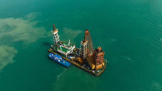 ship oil drilling rig in green sea aerial top view from drone