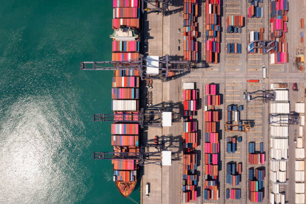istock Containers ship and shipping port cargo logistic freight load unloading by crane forwarding industry import export international worldwide, 1487235455
