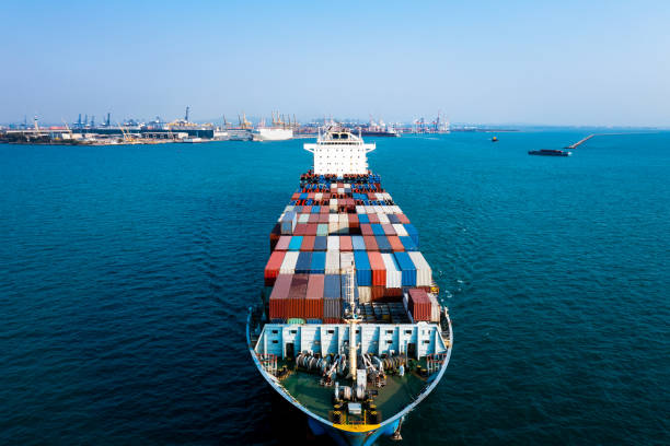 istock Aerial front view container cargo ship carrying commercial container in import export business commerce logistic and transportation of international by container ship 1487235456