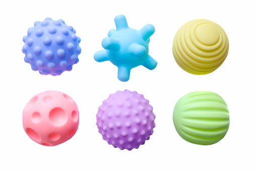 Baby rubber balls of different shapes isolated on white background.