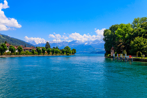 View of the Annecy lake surrounded by beautiful mountains in Annecy, France