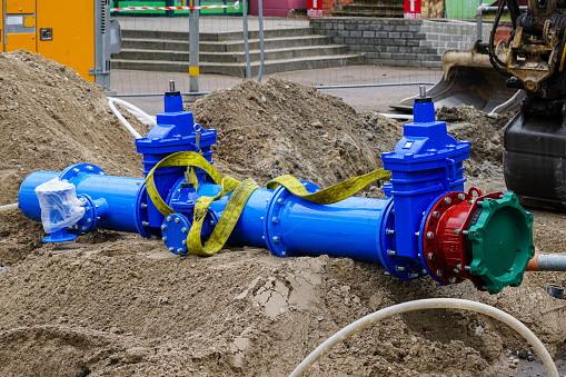 New modern 300mm city main drink water pipeline with gate valves before connecting to underground pipeline system on city street