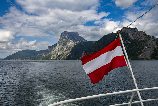 Gmunden, Austria, July 8, 2022: View of a rocky mountain above the Traunsee Lake in Upper Austria seen from a cruise ship. The region is also known as Salzkammergut, part of which is listed as UNESCO World Heritage Site.