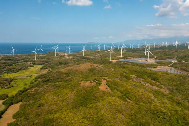 Wind turbines producing clean sustainable energy, clean energy future. Wind power plant. Philippines.