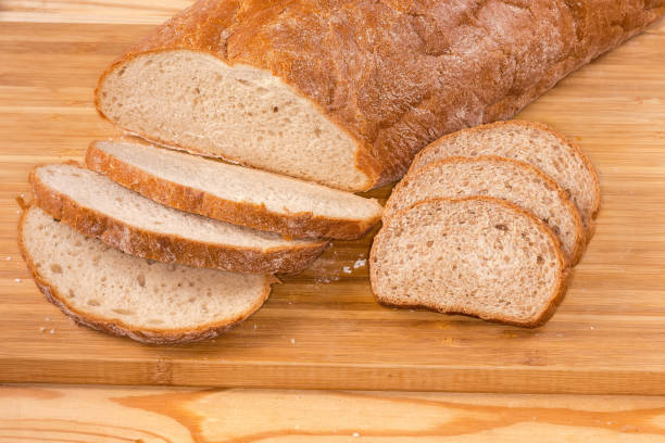 istock Sliced two loafs of bread with bran on cutting board 1487243428