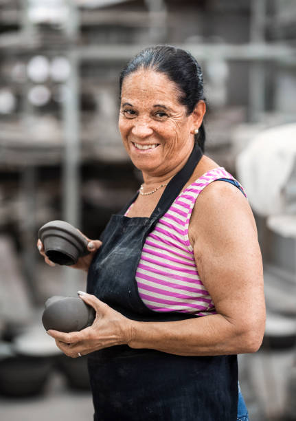 istock Smiling senior female worker making ceramic products in a workshop 1487244185