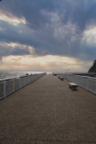 istock Bench in the seaside park at sunset 1487245759