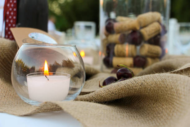 istock Outdoor wedding organization invited dining table and lit candle 1487246866