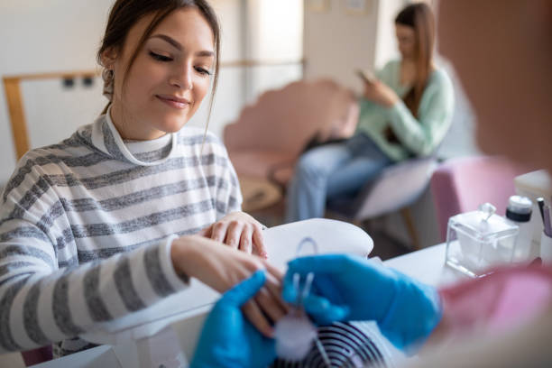 istock Young woman doing her nails in a nail salon 1487248351