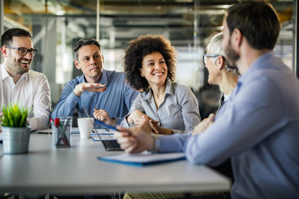 istock Group of happy entrepreneurs communicating while having a meeting in the office. 1487249793