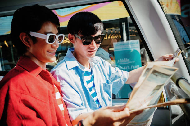 istock Young gay couple looking at a map 1487251300
