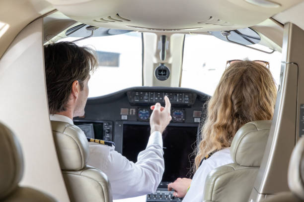 istock Pilots in the cockpit preparing flight path and check list, a man and a woman 1487251315