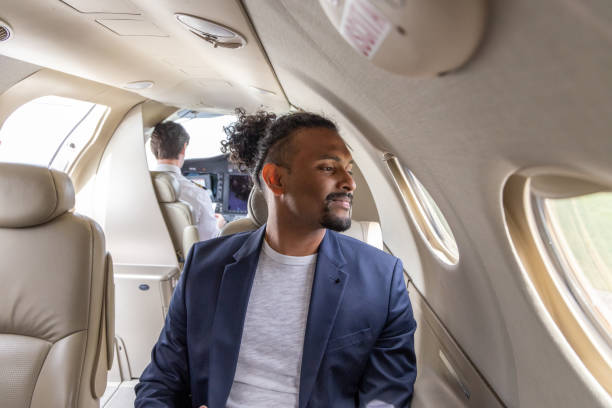 istock Young businessman working on digital tablet in a private jet plane 1487251408