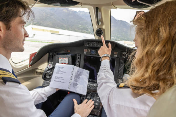 istock Pilots in the cockpit preparing flight path and check list, a man and a woman 1487251432
