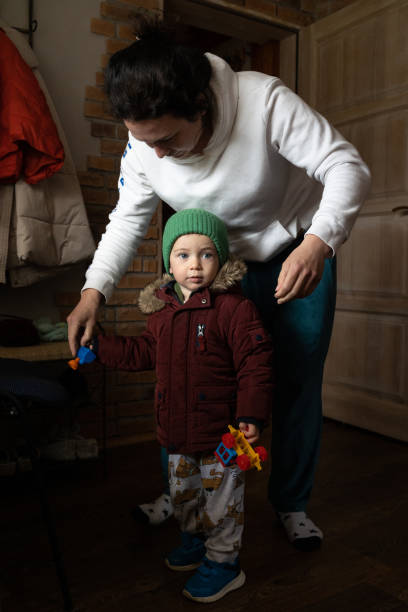 istock The mother dresses her son for a walk. 1487251450