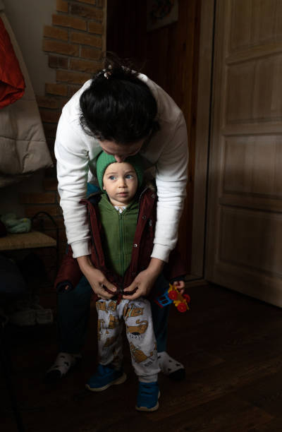 istock The mother dresses her son for a walk. 1487251457