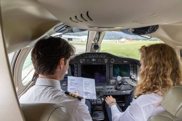 istock Pilots in the cockpit preparing flight path and check list, a man and a woman 1487251530