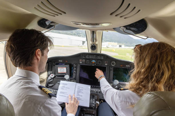 istock Pilots in the cockpit preparing flight path and check list, a man and a woman 1487251539