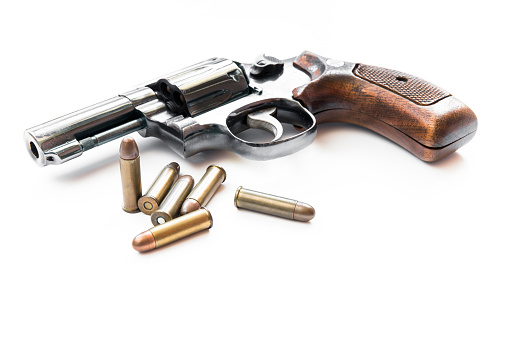 Parts of 1911 gun model and .45 bullets on white background