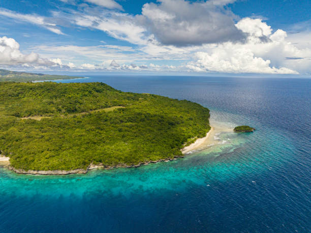 istock Flying above Tropical Island surrounded by deep blue sea. 1487252877