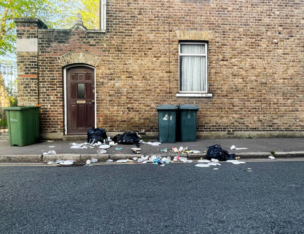 Bin bags split open on a suburban street