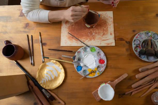 istock Female hands painting a pottery 1487253222