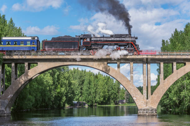 istock Retro steam train moves above the river. 1487253304